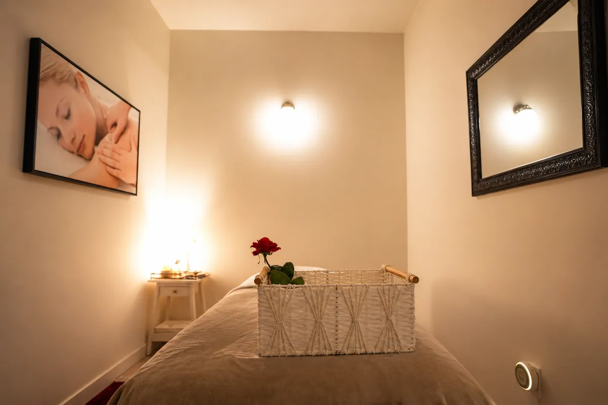 Candle-lit treatment room with massage table and rose accents