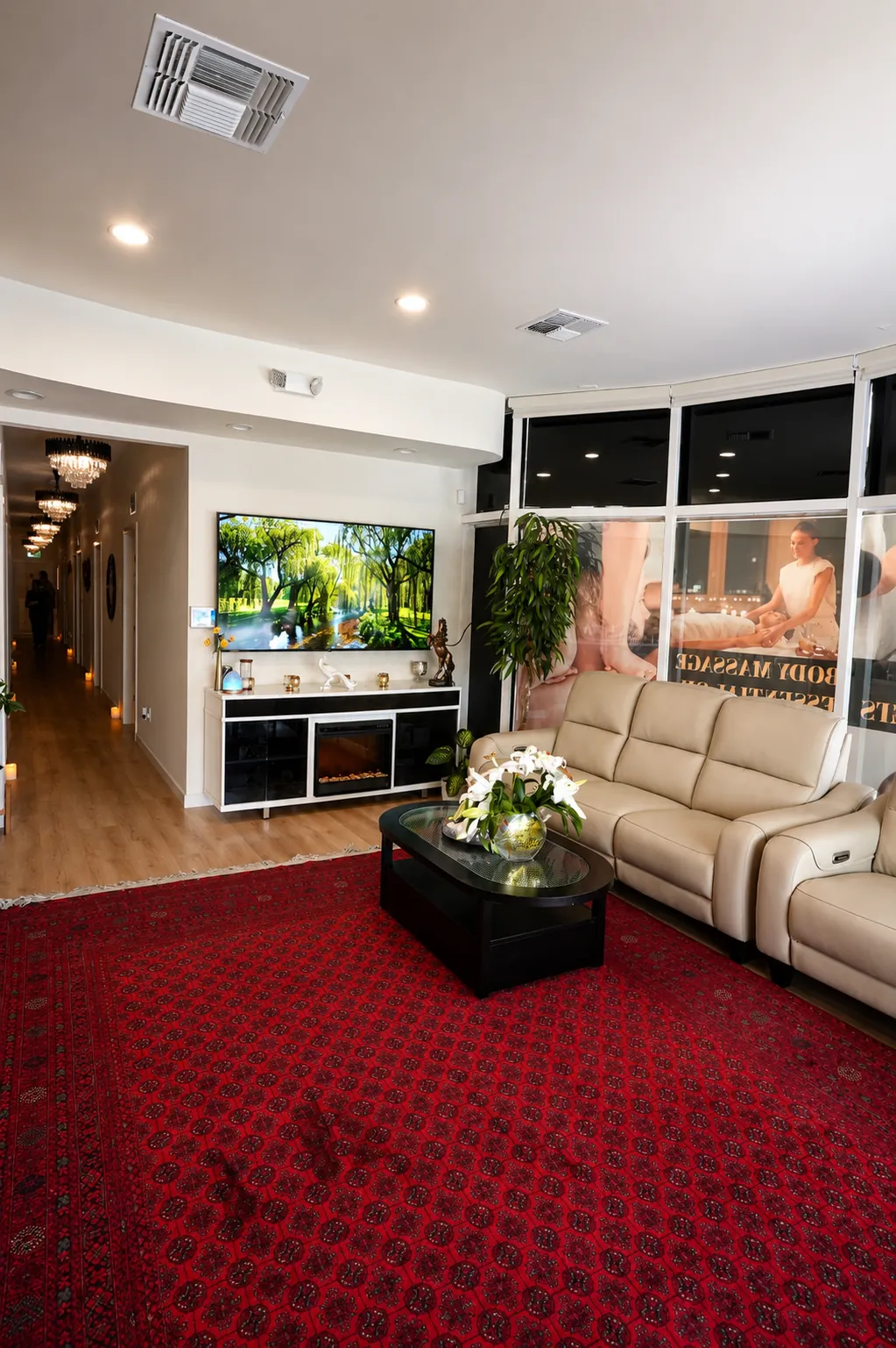 Lobby waiting area with sofas, fireplace, and candle-lit hallway