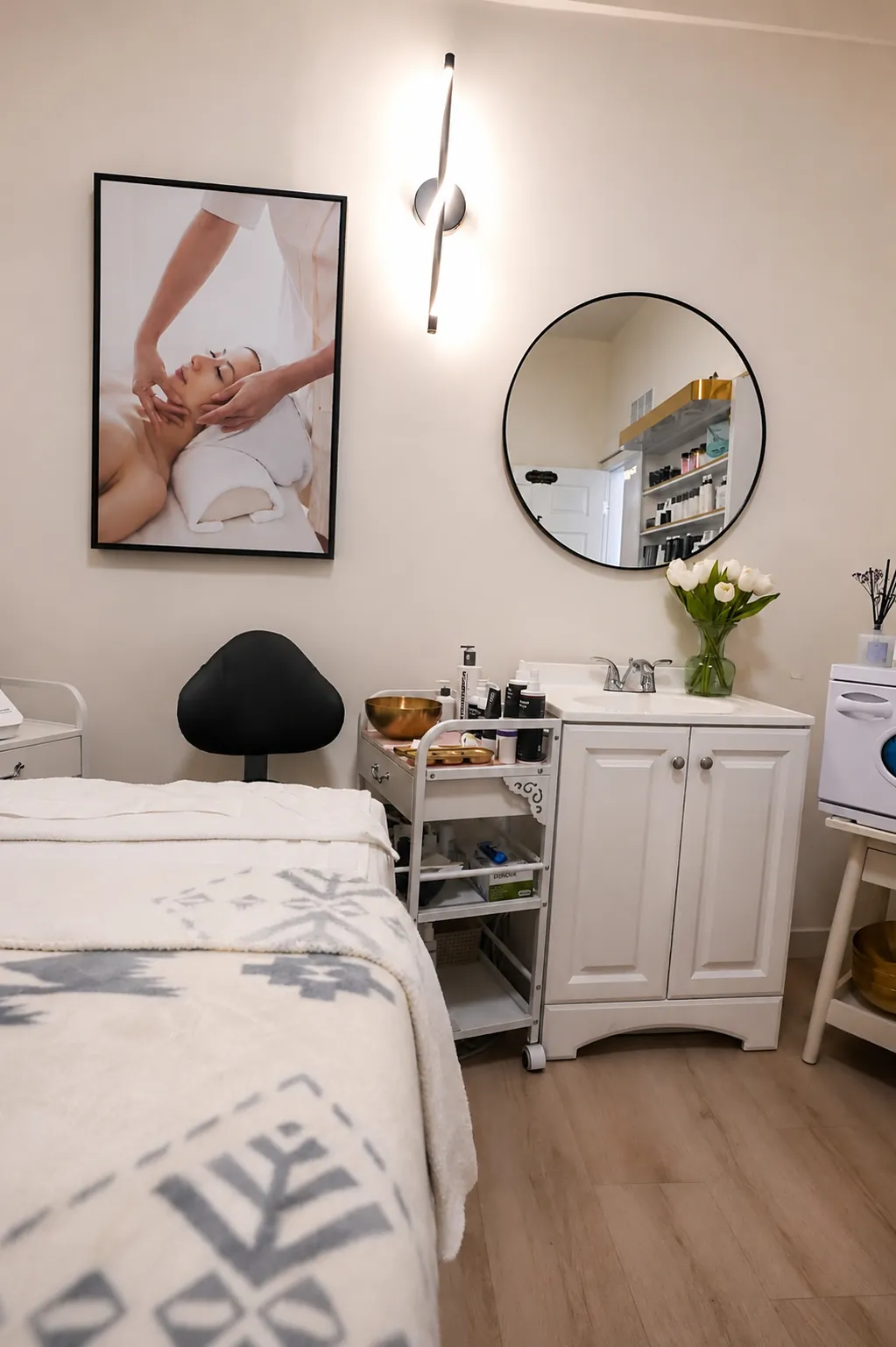 Clean treatment room with massage table and skincare station