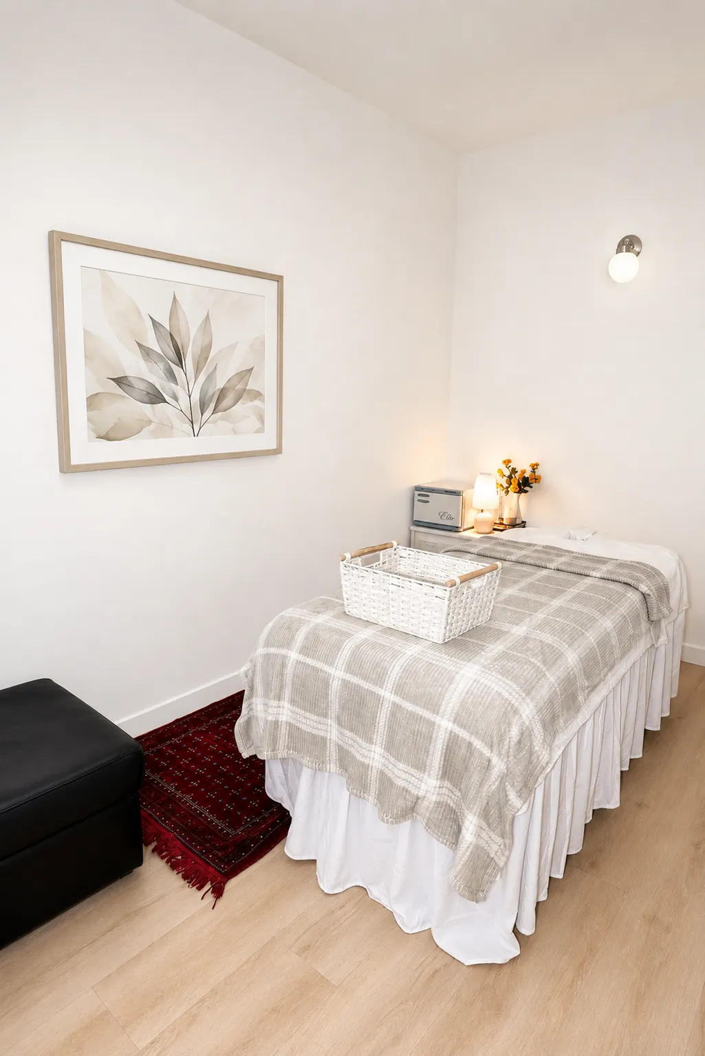 Cozy treatment room with skirted massage table and warm lighting