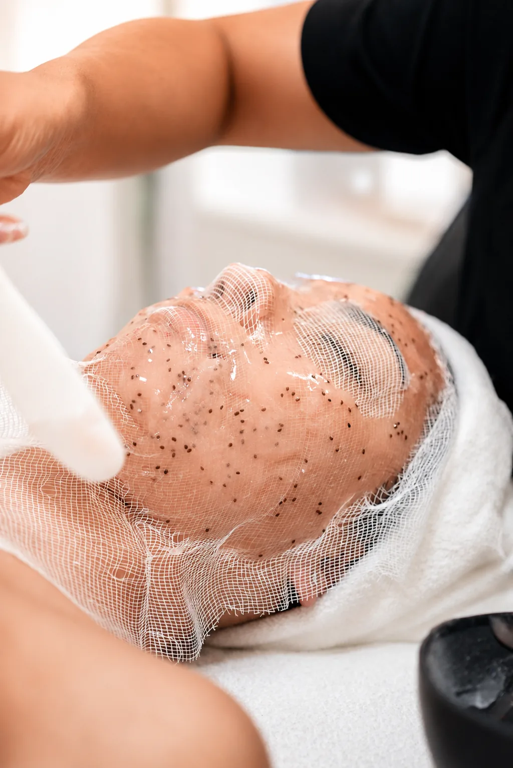 Close-up of an exfoliating scrub facial in progress