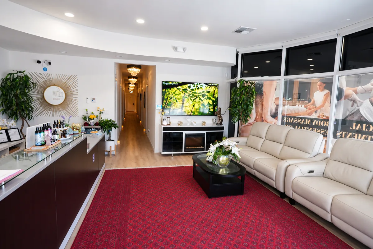 Lobby lounge with leather recliners, fireplace, and television