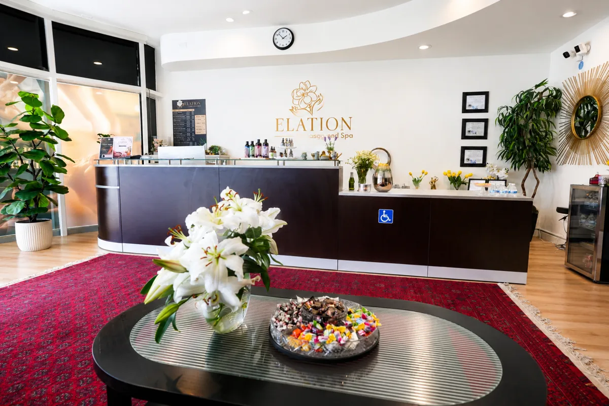 Reception area with fresh lilies and gold Elation logo