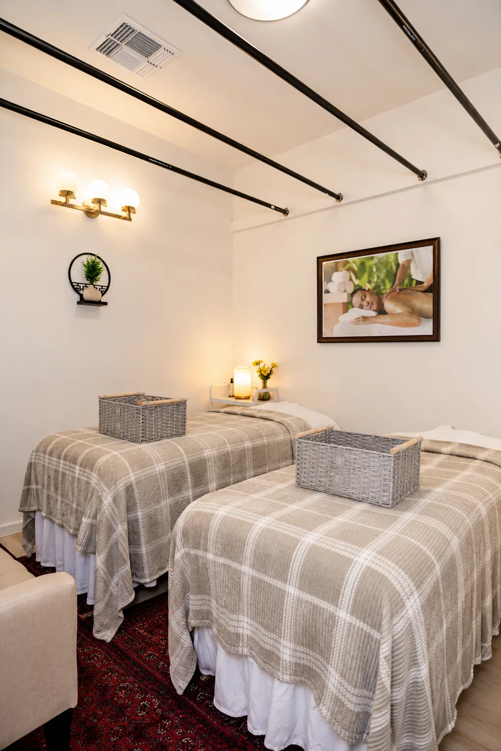 Couples room with two plaid-draped massage tables and gift baskets