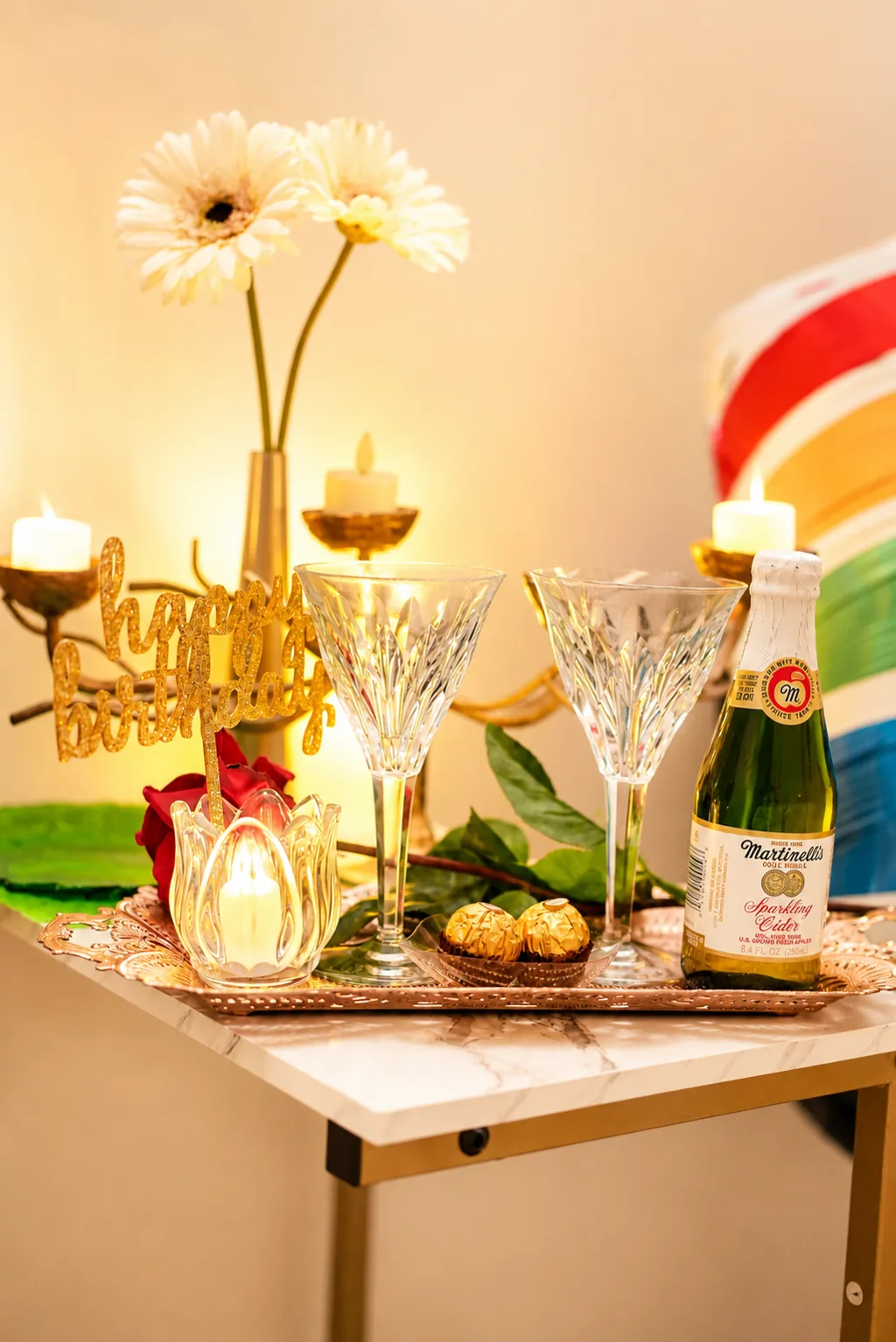 Celebration table with candles, champagne flutes, and sparkling cider