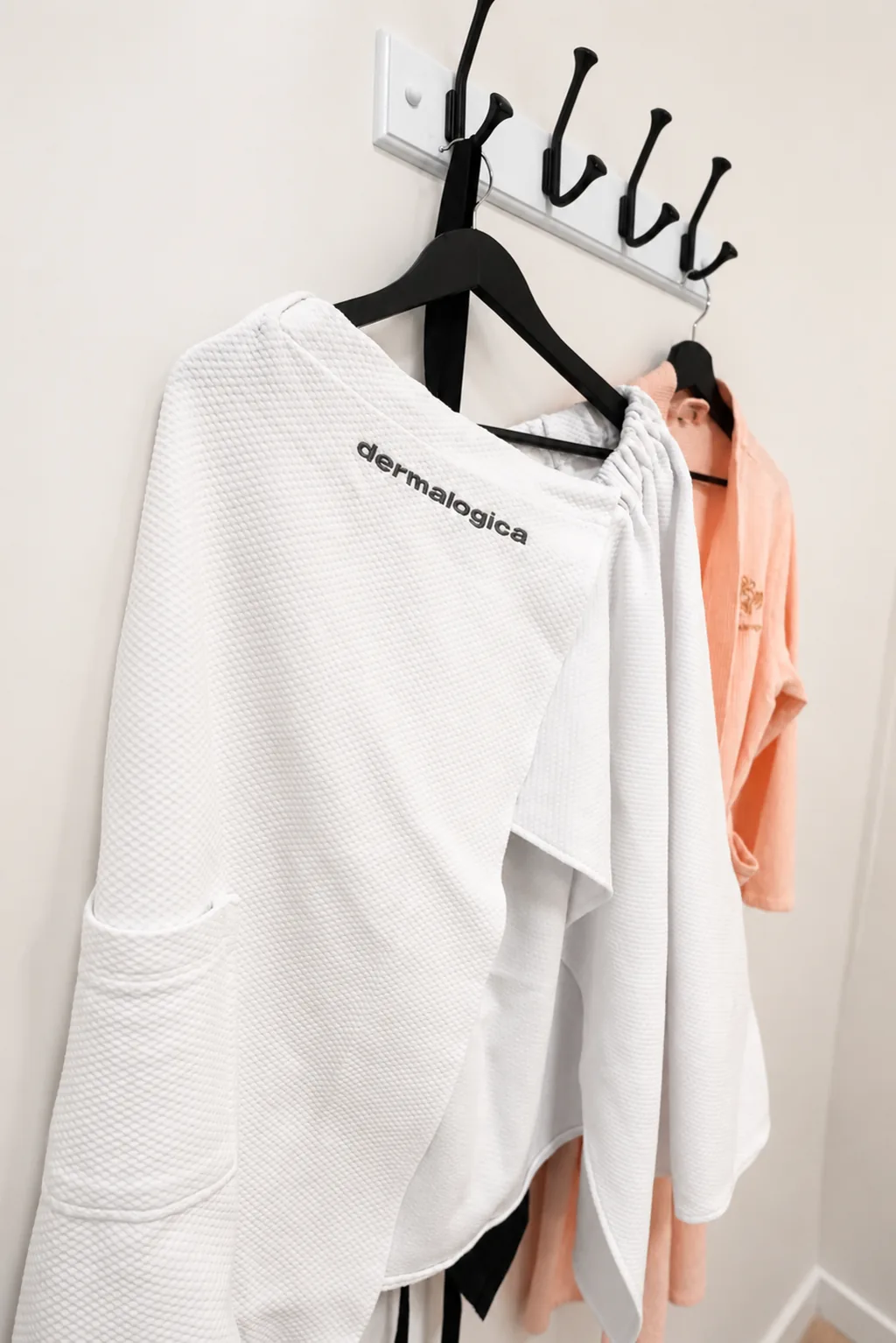 Dermalogica spa robe and towels hanging in a treatment room